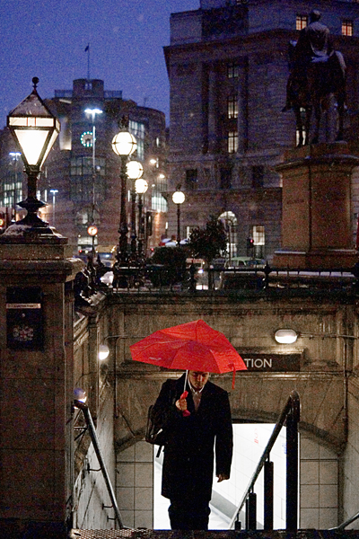 Red Umbrella - a single bold colour Red umbrella in the rain, London. By Damien Demolder